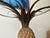 This striking pineapple-form coffee table is crafted from polychrome painted iron and features a circular inset glass top....