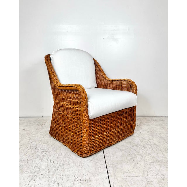 Vintage Wicker Works style woven wicker rattan lounge chair. Thick woven reeds with braided trim. Removable cushions.