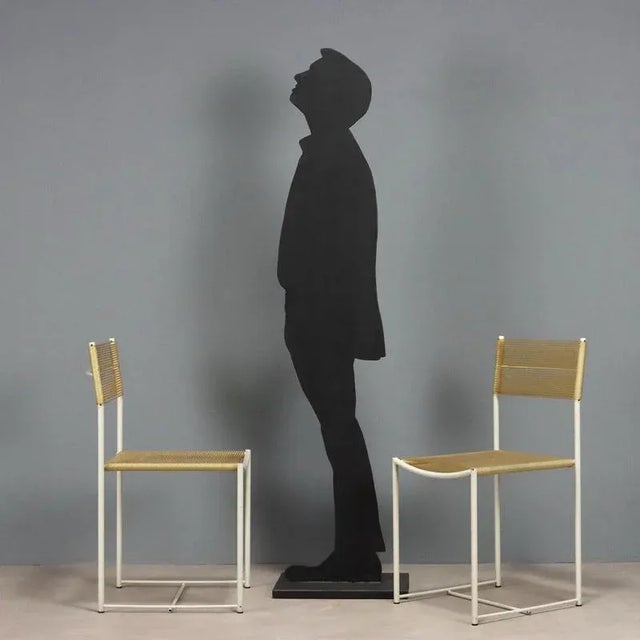 Set of chairs with white lacquered metal frame, PVC seat and backrest. This piece is attributed to the mentioned...