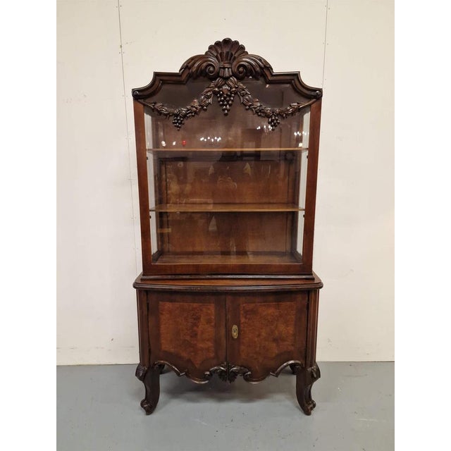 Beautiful display case.Wood carvings, walnut veneer, faceted glass.France.1930s.Size: height 195cm; length 103cm; depth 45cm