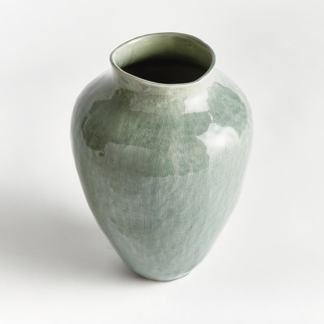 In a modern silhouette with a subtle linenlike texture, reactive glaze and high gloss finish, this ceramic vase is a...