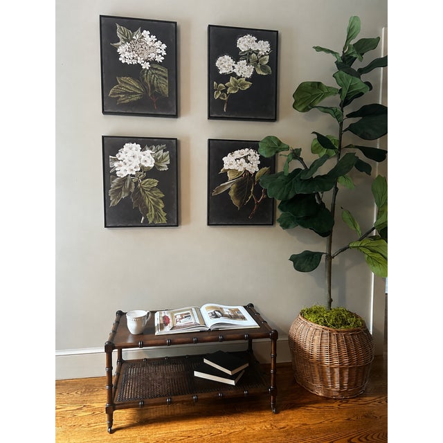 A charming vintage faux-bamboo coffee table featuring a rich dark walnut-toned finish, inset wood top, woven cane lower...