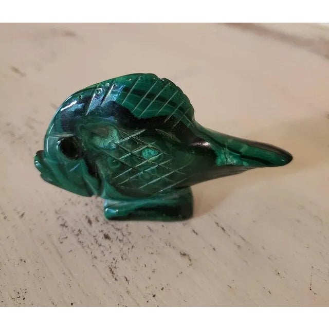 A beautiful, natural, solid, and substantial hand carved and polished bright green malachite stone in the shape of a fish...