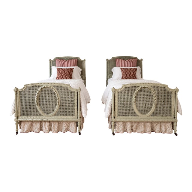 Pair of Antique French Louis XVI–Style Painted Cane Twin Beds With Carved Floral Medallions | 1900 For Sale