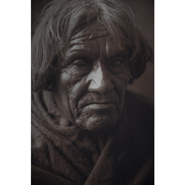 Among the most arresting portraits in the early volumes of The North American Indian, this photogravure presents an...