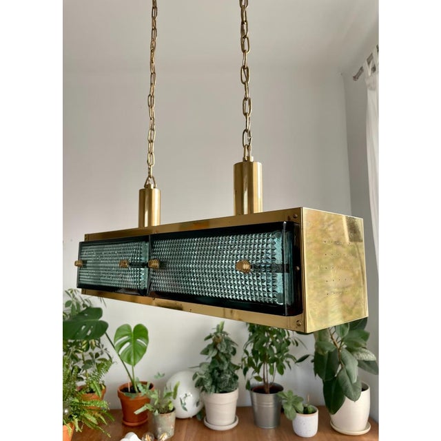 This stunning chandelier is made of brass and pressed glass. The bulbs are hidden under two additional crystal shades...