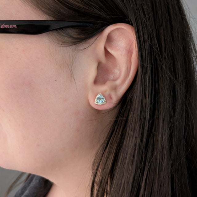 Add a little magic with these cool sky-blue Sky Blue Topaz stud earrings, set in solid 14K Yellow Gold. Each earring...