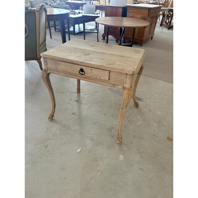 An elegant and richly patinated 18th century provincial French side table or writing table, beautifully bleached to reveal...