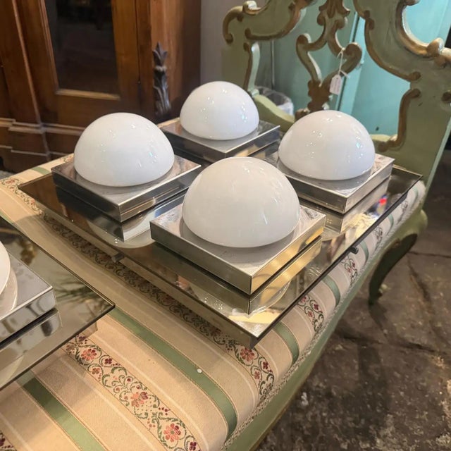 A set of two chromed metal, brown mirror and glass square wall lights also usable as ceiling lights designed and...
