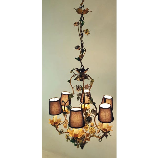 Chandelier from the 1950s in iron and painted with a natural vintage patina. It has six candle lights surrounded with...