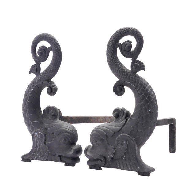 A pair of cast iron dolphin-form andirons by Bradley & Hubbard, manufactured in Meriden, Connecticut around 1900. Each...