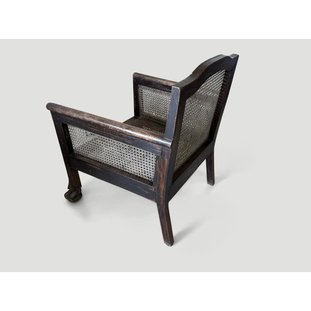 Beautiful teak framed colonial chair with lovely patina. Hand-carved feet and restored hand-woven rattan. A classic chair...