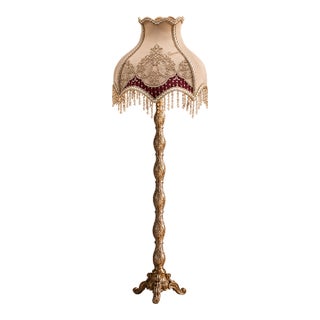 French-Style Gilded Floor Lamp – Ornate Gold Leaf Stand With Embroidered Burgundy & Ivory Shade For Sale