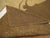 A large mid-20th century handwoven hooked rug featuring a oval floral palette in predominant soft brown. Other colors are...