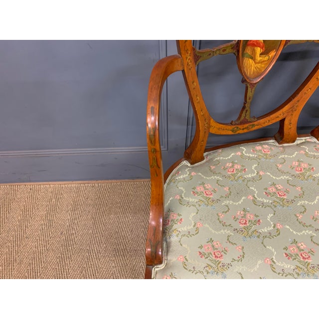 A lovely Edwardian period painted satinwood settee. Very constructed in solid satinwood and decorated with painted...