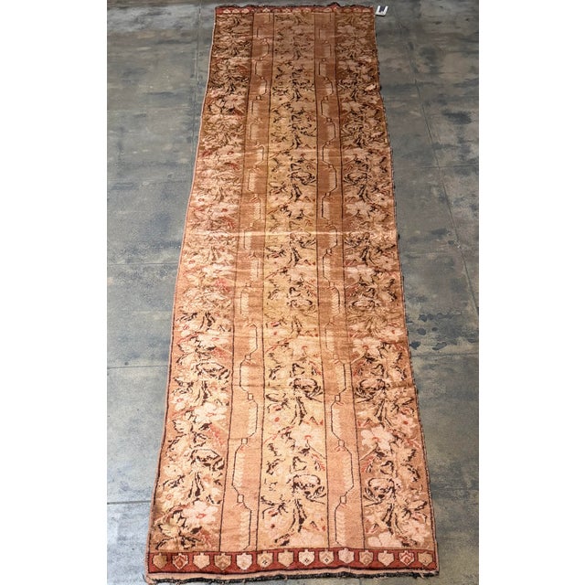 This antique Turkish runner rug, dating to circa 1900, features an unusually soft and sophisticated botanical composition...