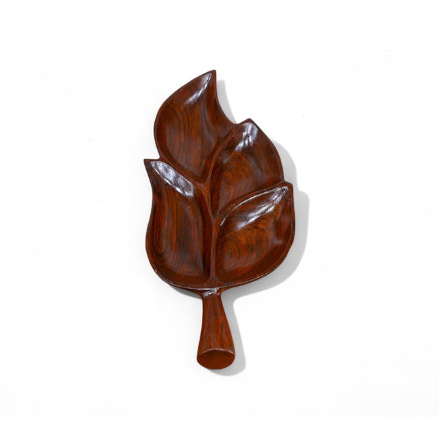 Handcrafted from noble wood, the serving platter features smooth curves and delicate woodwork emulating a tropical leaf...