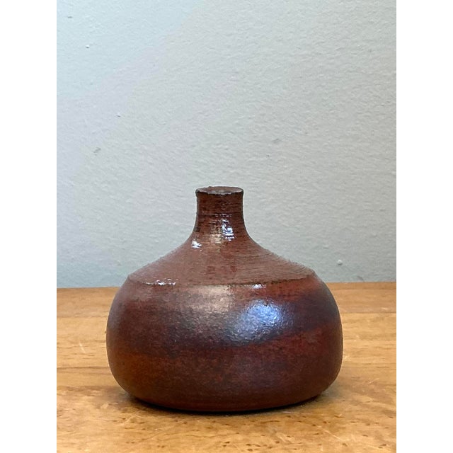 This exquisite hand-signed bud vase by P.F. McBride is a quintessential example of artisanal studio pottery. Thrown with a...