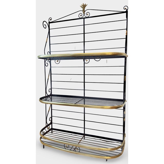 Presented for your consideration is a splendid three-tier bakers rack, exquisitely fashioned from black wrought iron...