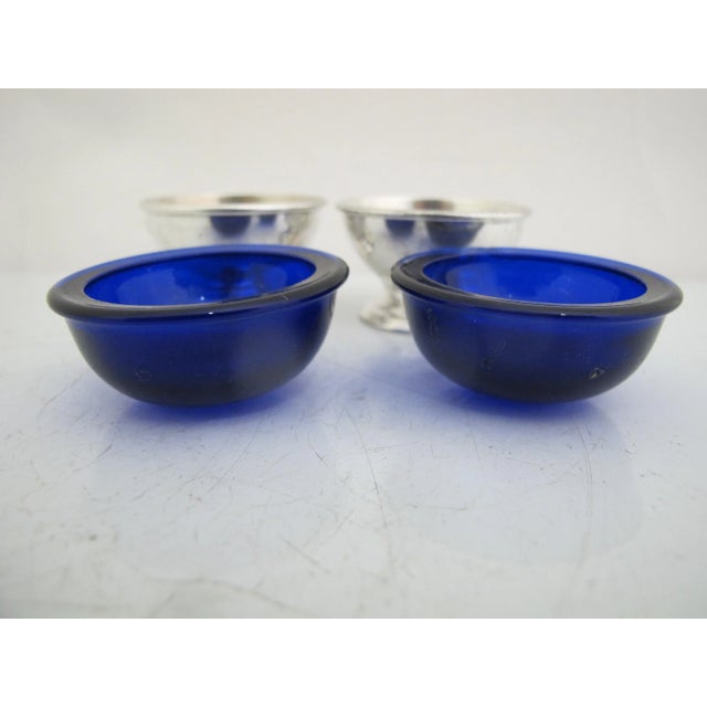 Pair of Reed & Barton sterling silver pedestal salt cellars with cobalt glass liners. Excellent condition, one liner has a...