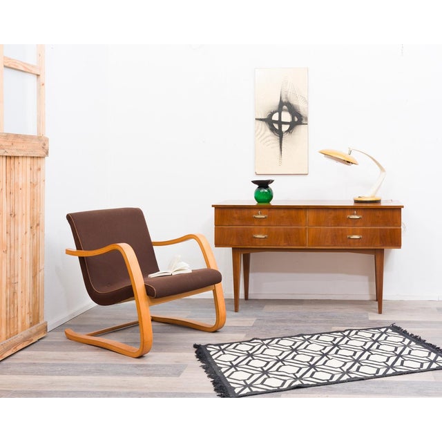 Sideboard/chest of drawers from the 1950s in walnut with four spacious drawers and original brass fittings. This piece...
