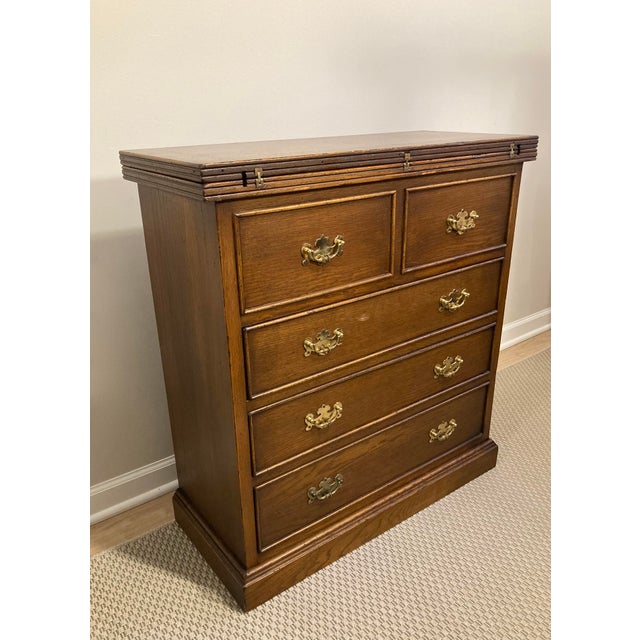 This petite Chippendale-style secretary chest produced for Marshall Field's features a unique flip-top which raises a...