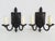 Antique early 20th century pair of Spanish Revival wrought iron wall sconces. The hand forged sconces feature a back...