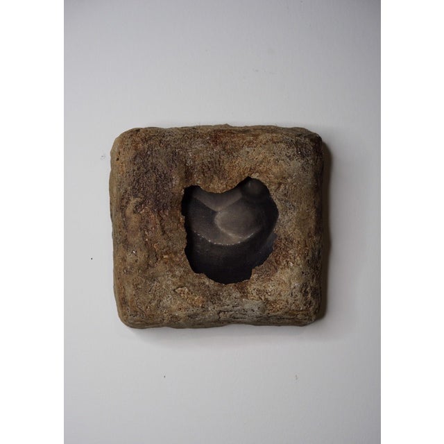 Excavation 2 presents a textured, organic form that appears to emerge from a weathered surface, evoking a sense of ancient...
