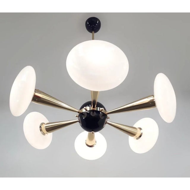 Italian chandelier with Murano glass shades, mounted on polished brass frame with black enameled center and ceiling canopy...