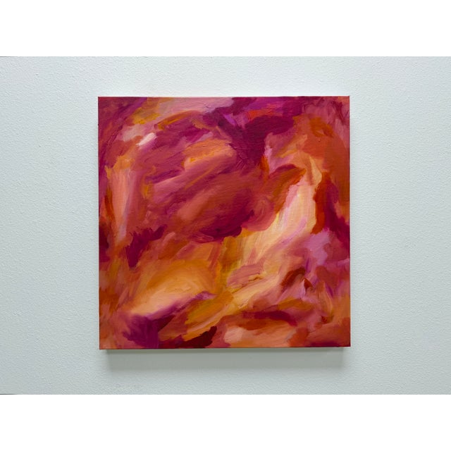 This original abstract painting features layered brushwork in warm pinks, coral, ochre, and golden tones, creating a sense...