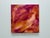This original abstract painting features layered brushwork in warm pinks, coral, ochre, and golden tones, creating a sense...