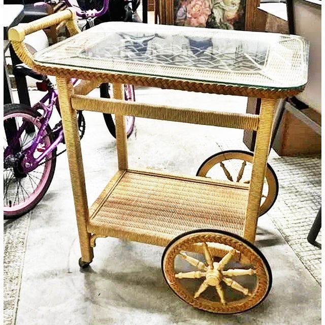A classic hand wrapped wicker serving cart with glass top likely by Henry Link or Lexington from the 1970-80s, wrapped...