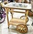 A classic hand wrapped wicker serving cart with glass top likely by Henry Link or Lexington from the 1970-80s, wrapped...
