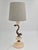 A beautiful, sculptural Swedish Grace table lamp in alabaster with metal decor of dolphin. Nice patina, smaller signs of...