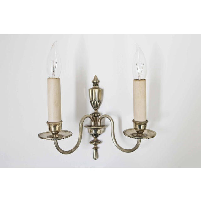 Neoclassical wall lights Set of 3 Brass, possibly nickel-plated Silver color Italy, 1980s Height 27cm Width 25cm Depth...