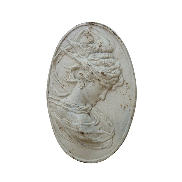 Mid to early century white painted cast iron oval bas relief cameo garden plaque showing a neoclassical / art nouveau...