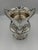 A commanding example of American silver craftsmanship, this monumental three-handled loving cup in made of sterling...
