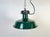 Industrial dark green enamel pendant light made in France during the 1960s. White enamel inside the shade. Cast iron top....