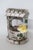 resemble stone texture, which is accented with lovely pink, yellow, and blue blossoms. There is a little bucket hanging by...