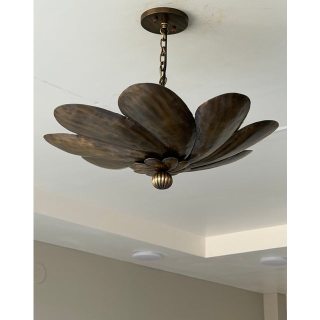 Bring timeless elegance and artistic character to your space with this handmade antique brass floral pendant light...