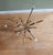 Beautiful and delicate accent round table with a sheaf of wheat gold metal base, crowned by a round glass top, in the...