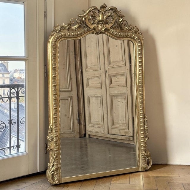 A 19th century French Napoleon III period gilded mirror, as luminous today as when it first graced a Parisian salon. An...
