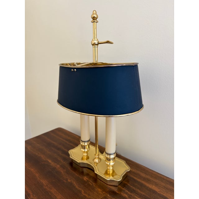A gorgeous brass bouillotte lamp with black tole shade USA, Mid-20th century Measures: 9" W x 6.25" D x 16" H Very good...