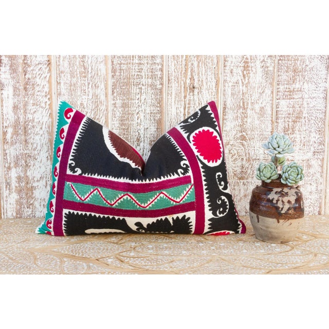 Made from a vintage Suzani tapestry, it features hand done embroidery and a solid linen back. Suzani is a Persian word...