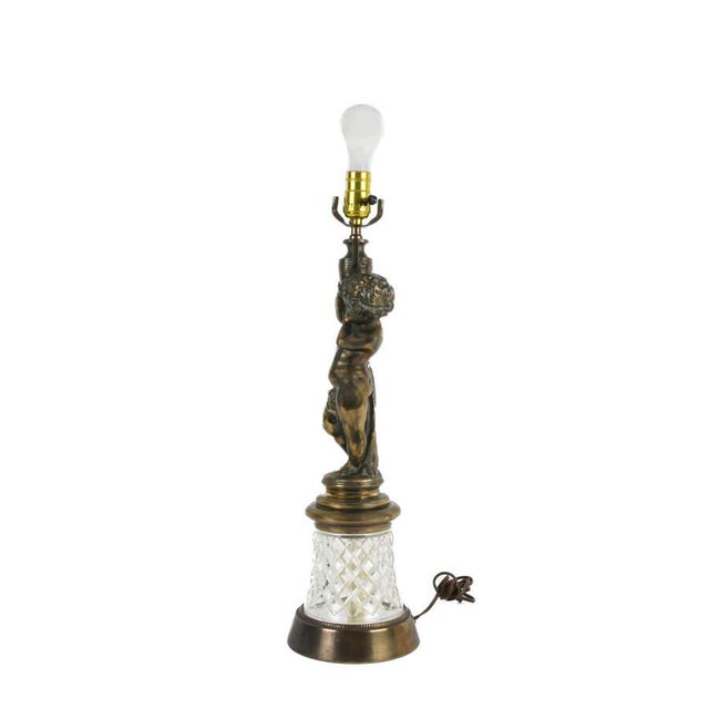 This vintage cast metal cherub and crystal table lamp features an intricately sculpted classical cherub rendered in solid...