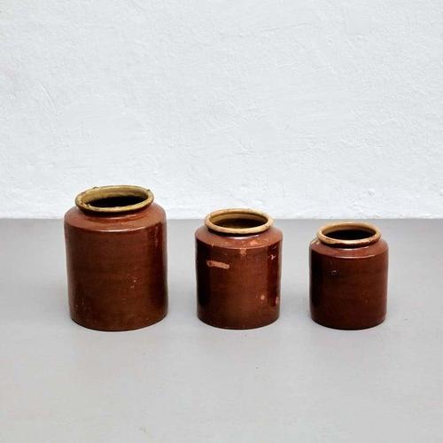 This set of three rustic ceramic vases is a beautiful example of early 20th-century Spanish craftsmanship. Each piece was...