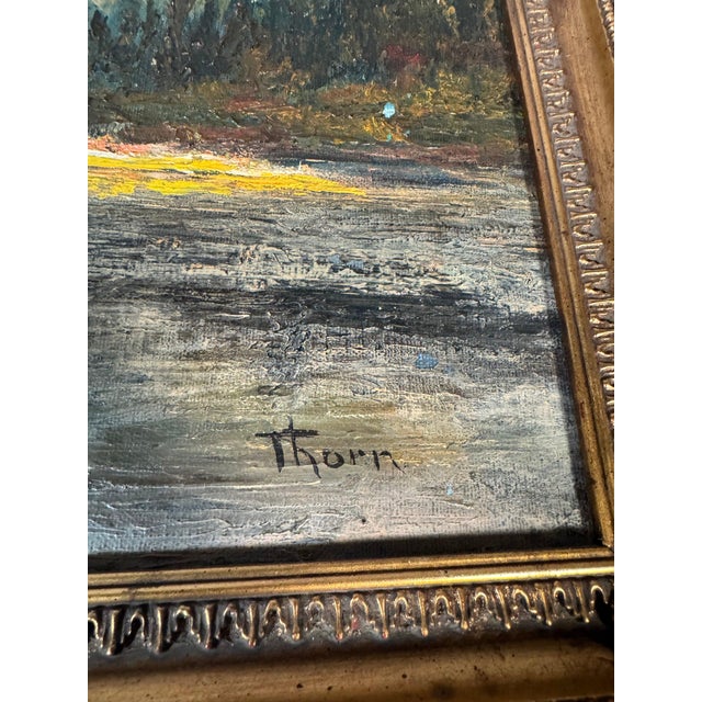 An original oil on canvas of an alpine lake at sunset: a sunlit peak in warm gold and orange reflected in still blue-grey...