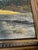 An original oil on canvas of an alpine lake at sunset: a sunlit peak in warm gold and orange reflected in still blue-grey...