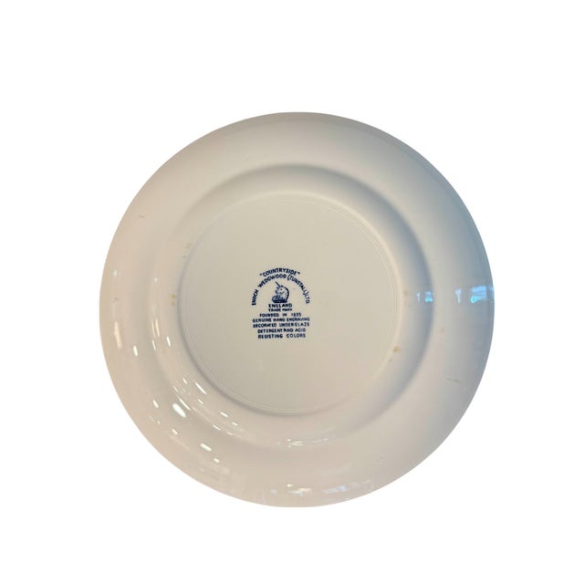 Enoch Wedgwood "Countryside" Blue & White Plate This white porcelain plate features a countryside scene. There is a...