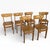A charming set of six mid-century dining chairs featuring classic butterfly back silhouettes with mustard-yellow vinyl...